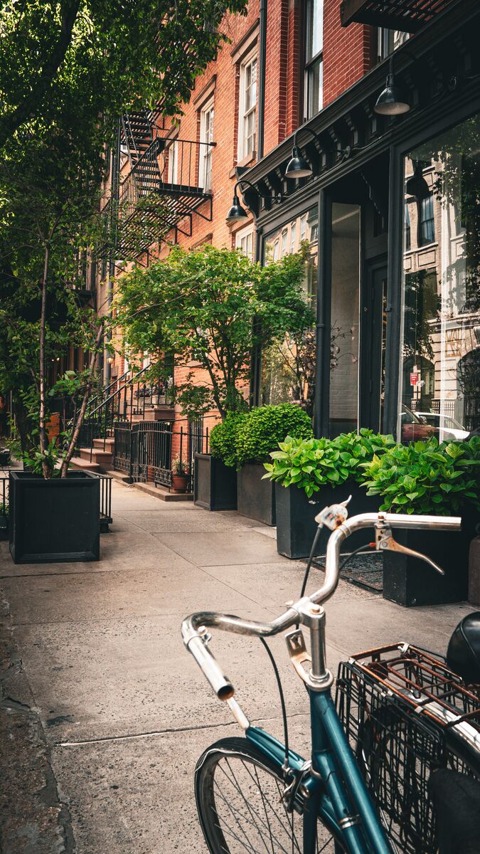 Brooklyn sidewalk with bicycle and brownstones