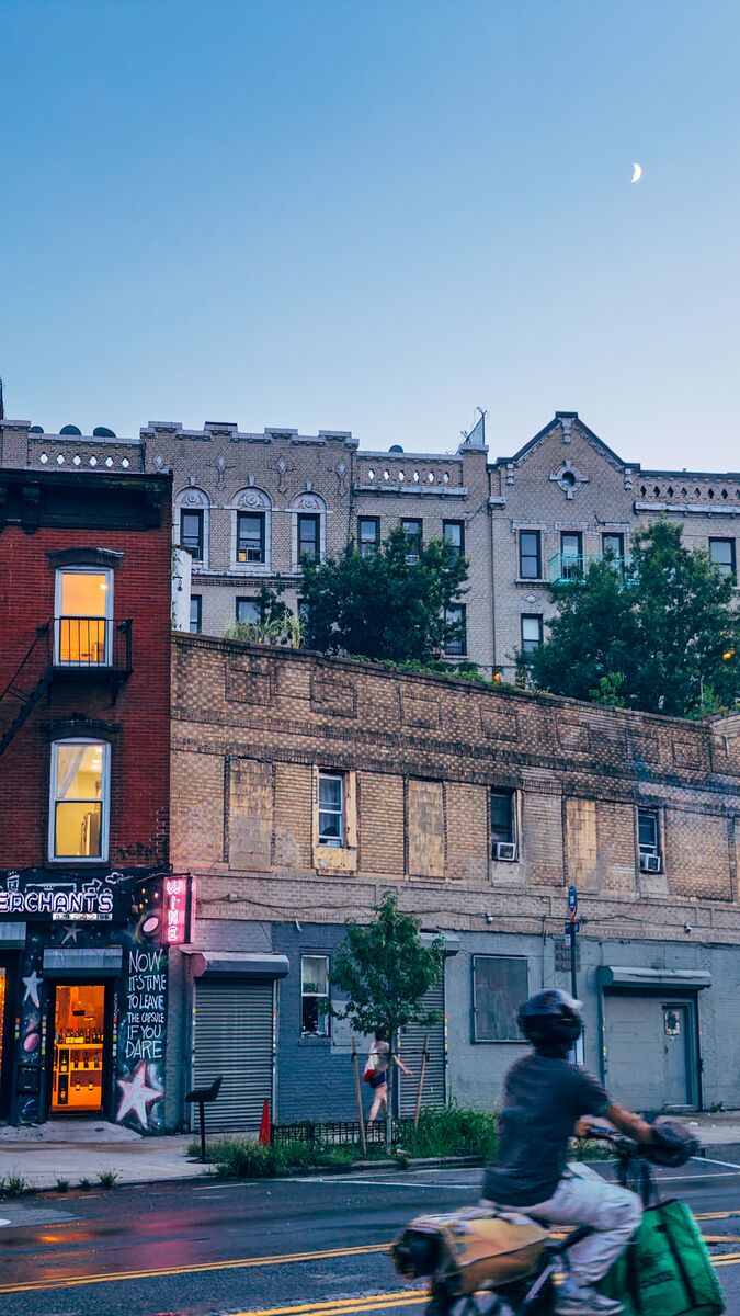 NYC street scene with moon and buildings