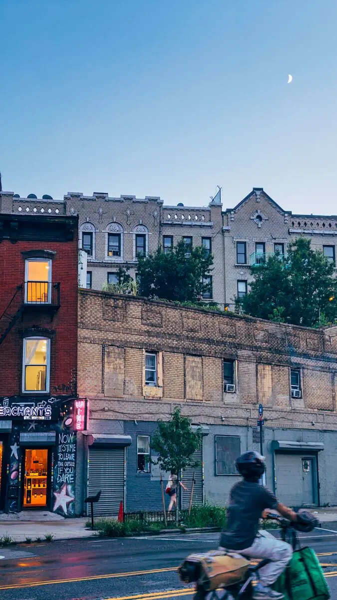 NYC street scene with moon and buildings